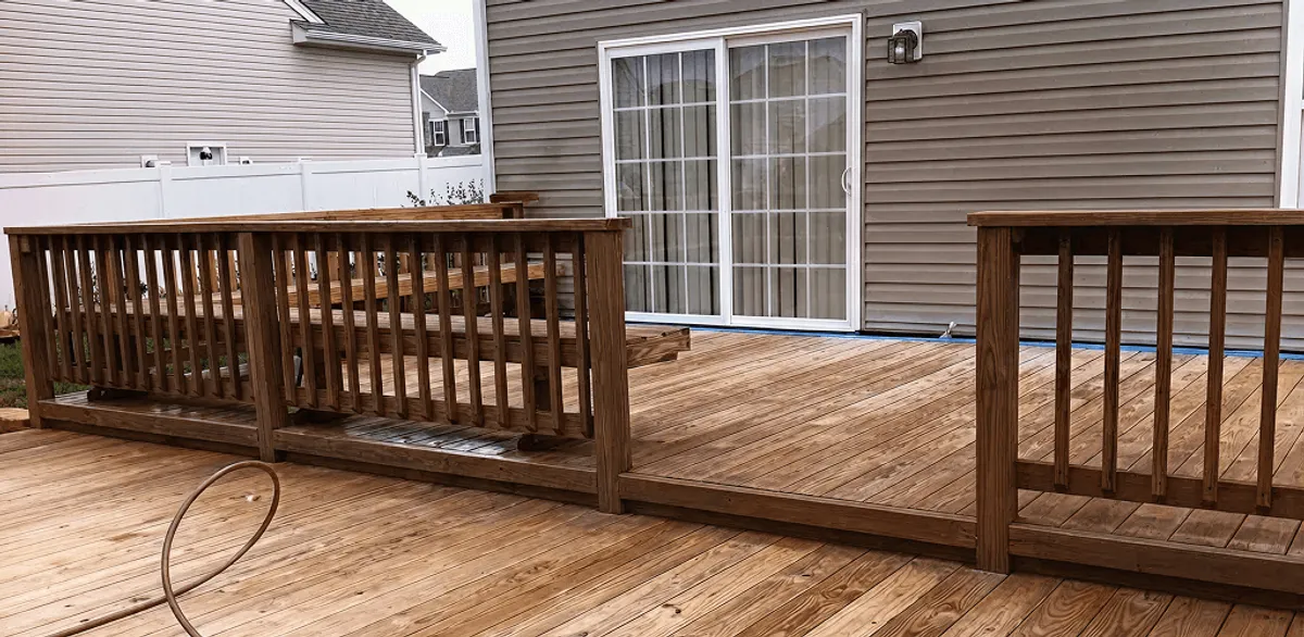 Deck sealing service protecting a backyard wood deck and railings in Fargo, ND