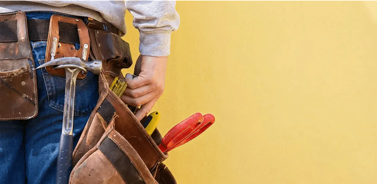 Handyman with tool belt ready for home repairs and maintenance in Fargo, ND
