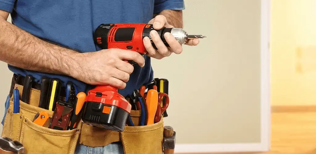 Handyman holding a power drill for home repairs and installations in Fargo, ND