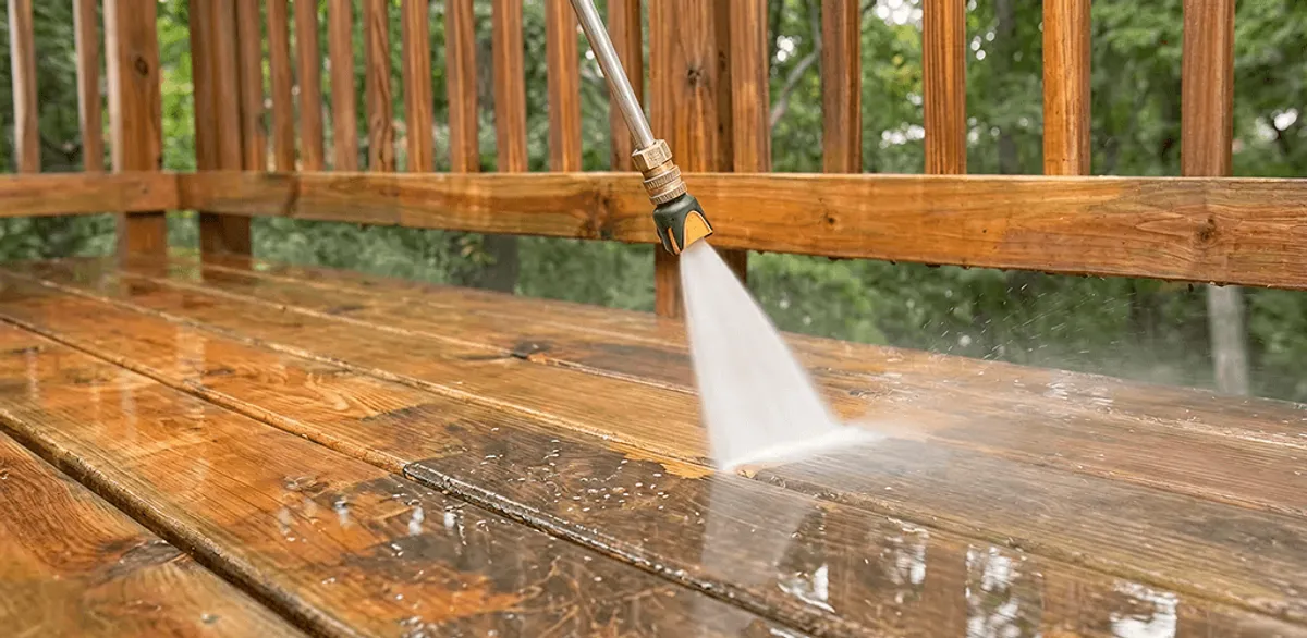 Pressure washing a wood deck to remove dirt and buildup in Fargo, ND