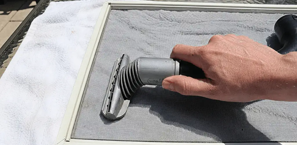 Window screen repair cleaning and fixing a damaged screen mesh in Fargo, ND